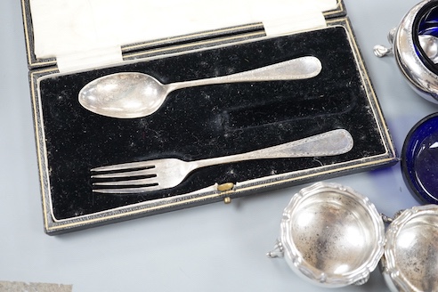 A pair of Victorian silver bun salts with blue glass liners and spoons, a spare liner, a later pair of small silver salts, a silver pepperette, a small silver box and a silver christening pair in box for three.